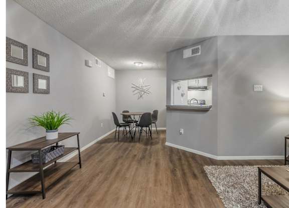 A living room with a dining table and chairs.
