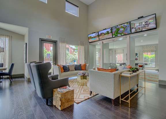 a living room with gray walls and a dark wood floor