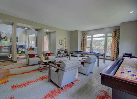 a large living room with a pool table and a foosball table