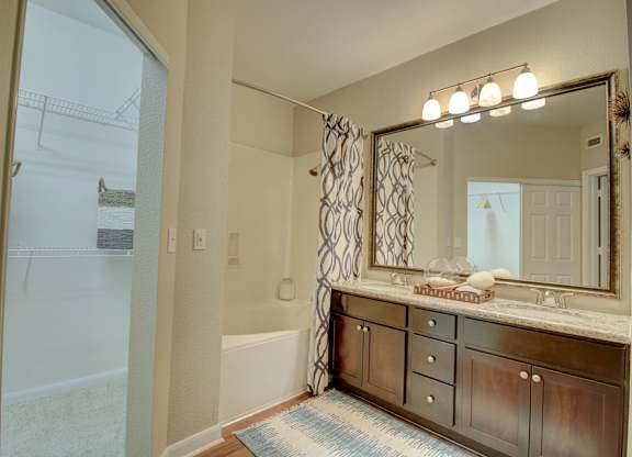 a bathroom with a large mirror and a bathtub