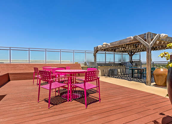 A wooden deck with a table and chairs.
