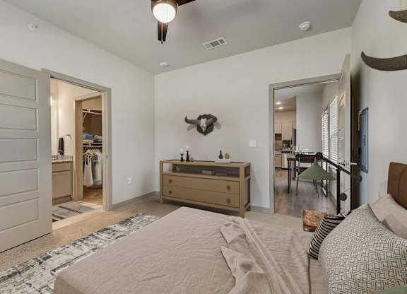 a bedroom with a bed and a dresser and a closet