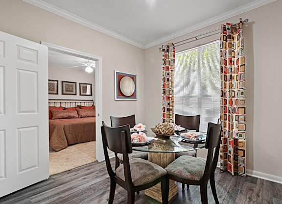 A dining room with a table set for two.