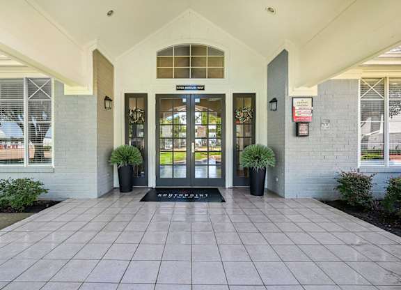 an entrance to a building with doors and windows