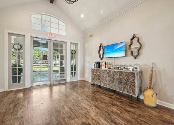 the living room of a house with a bar and a door to a patio