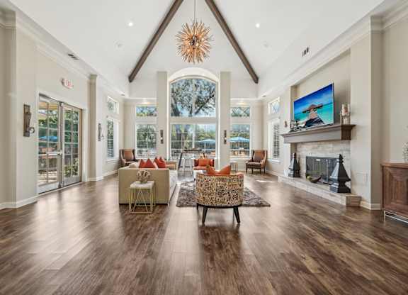 a large living room with a fireplace and a large window