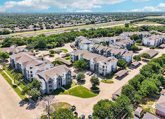an aerial view of a neighborhood with houses and trees