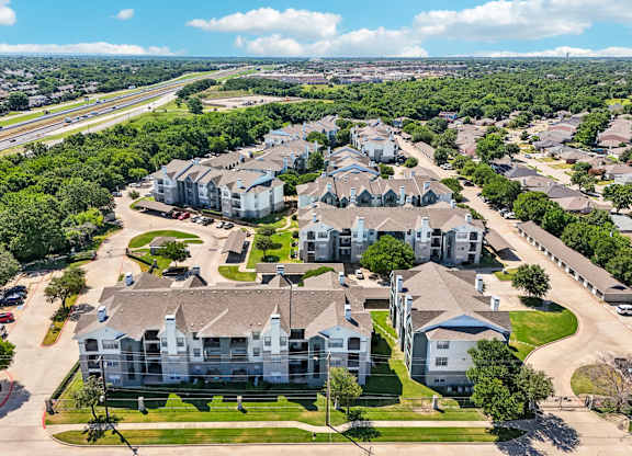 an aerial view of a neighborhood with houses and trees
