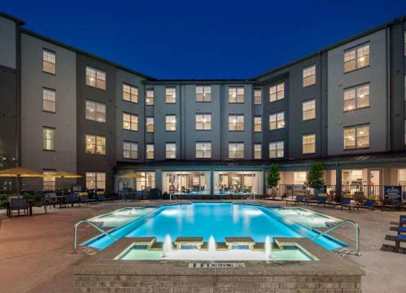 a large swimming pool in front of a building