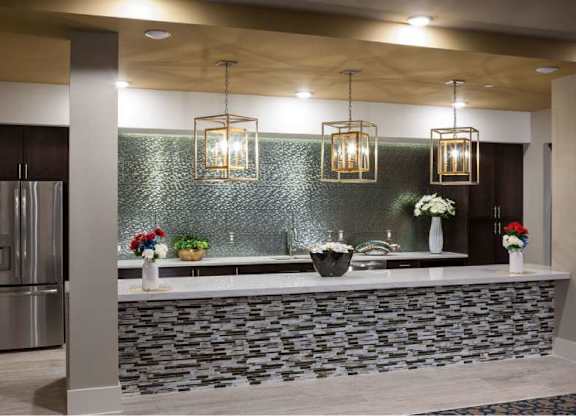 a kitchen with a counter and a stainless steel refrigerator