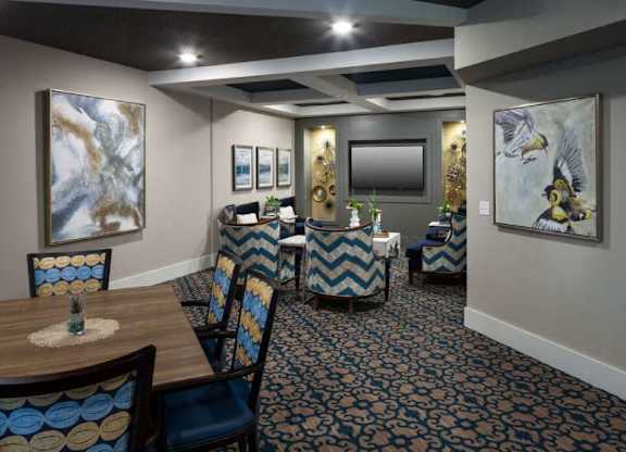 a dining room with tables and chairs and paintings