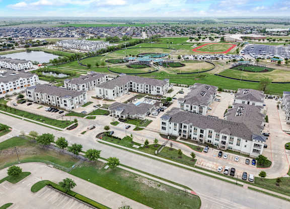 an aerial view of a community with houses and a parking lot