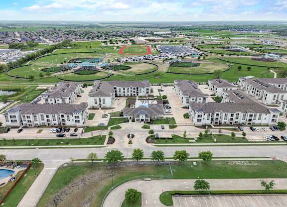an aerial view of a neighborhood with houses and a parking lot