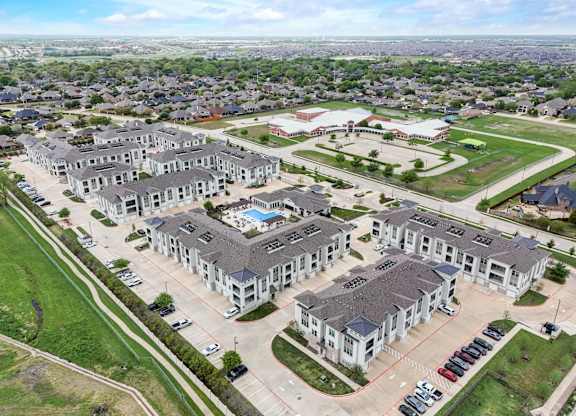 an aerial view of a group of houses and a parking lot
