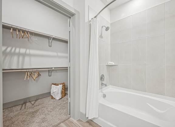 a bathroom with a shower and a tub and a shower curtain