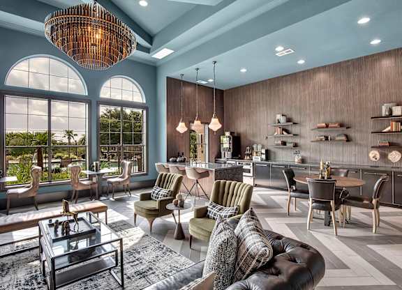 Open lounge and bar area with tall windows, mixed seating, and modern finishes.