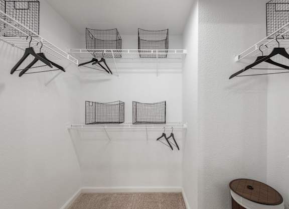 Walk-in closet with wire shelving, hanging space, and organized storage baskets.