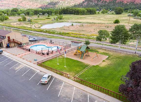 a view of the playground and pool from the top of the building
