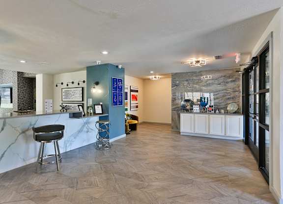 A spacious room with a marble counter and a black chair.