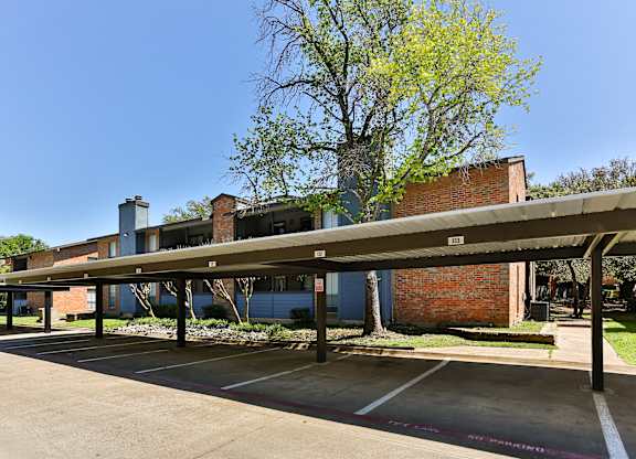 A parking lot with a building in the background.