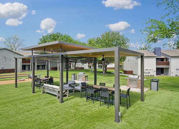a patio with a table and chairs under a canopy