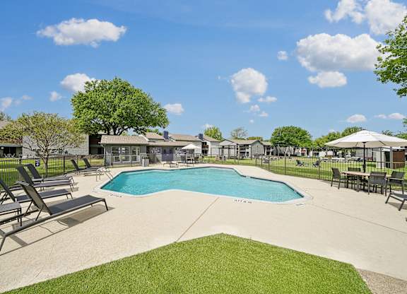 the preserve at ballantyne commons pool and patio with chairs and umbrellas