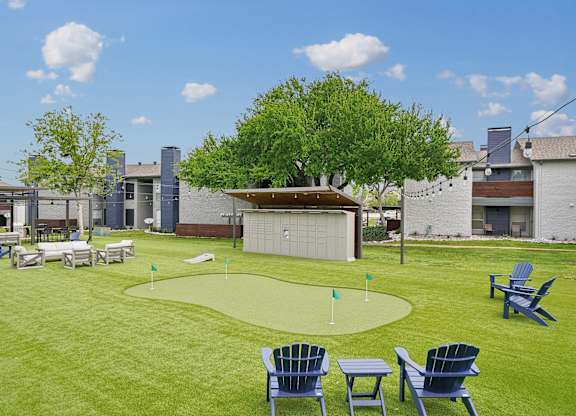 a yard with lawn chairs and a mini golf course