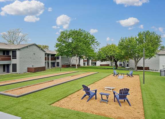 our apartments have a large yard with tables and chairs
