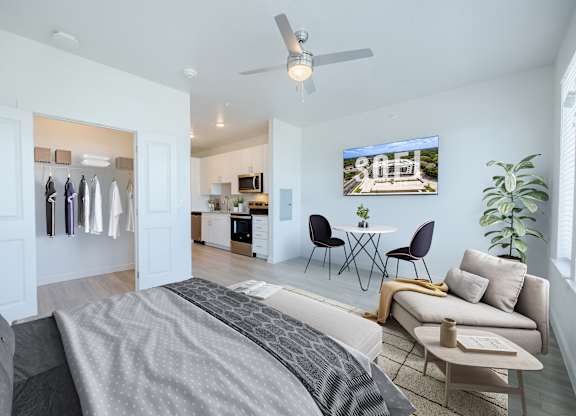 A modern bedroom with a large bed and a flat screen TV mounted on the wall.