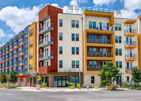 a new apartment building with a street in front of it