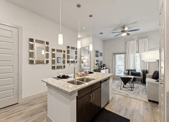 A modern kitchen with a large island and a dining area.