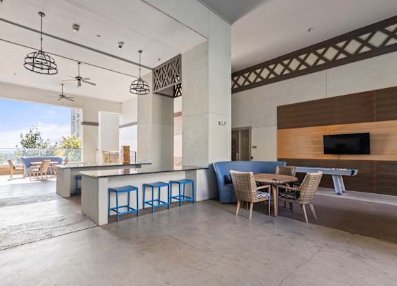 A modern open plan living and dining area with a bar.