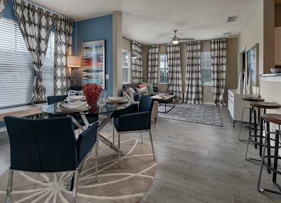 an open floor plan with a dining table and chairs