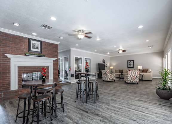 A living room with a fireplace and a bar area.