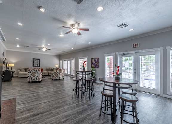 A spacious room with a ceiling fan and a couch.