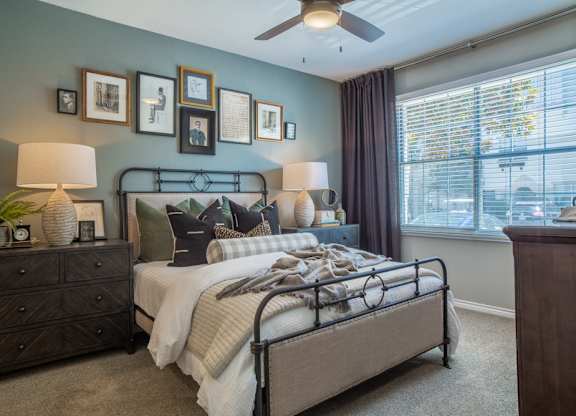 a bedroom with a bed and a ceiling fan
