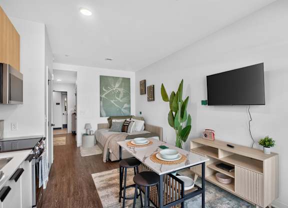 A modern kitchen with a dining table set for two at The Indie in Allston.