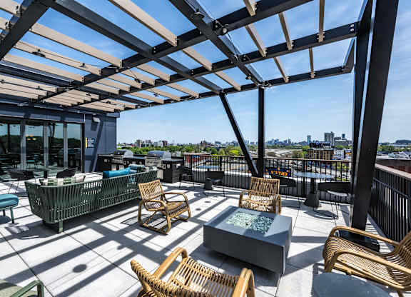 A patio with a table and chairs under a roof.