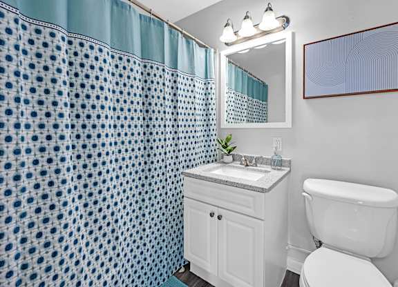 A white toilet sits next to a sink in a bathroom.