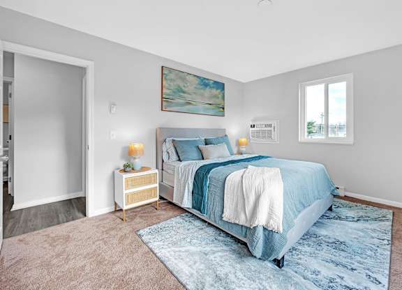 A bedroom with a large bed and a painting on the wall.