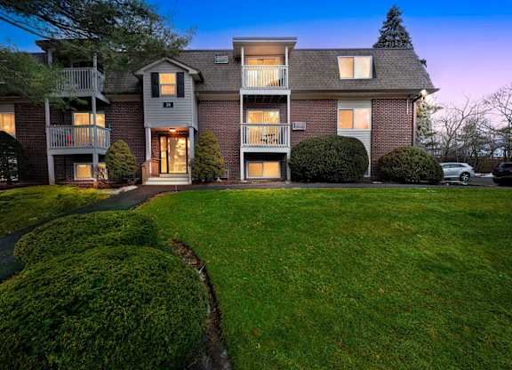 A large house with a lawn in front.