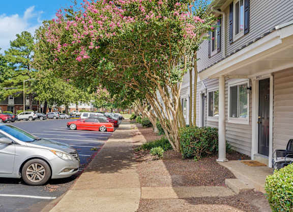 A silver car is parked on the side of a street.