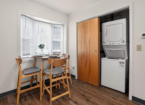A small dining room with a table and chairs.