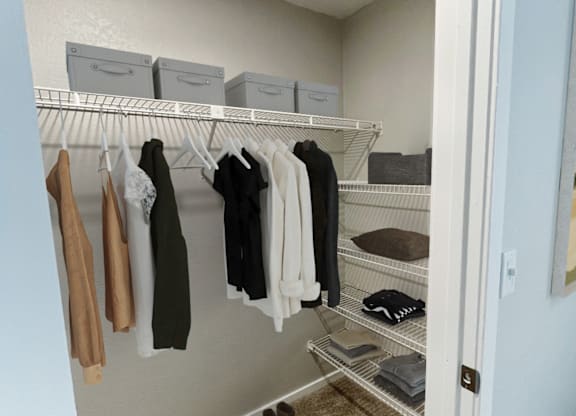 walk in closet with clothes hanging on the racks and folded on shelves at The Meadows, Chelmsford, Massachusetts