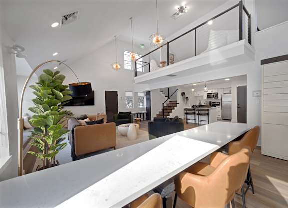 A modern dining area with a long table and chairs.