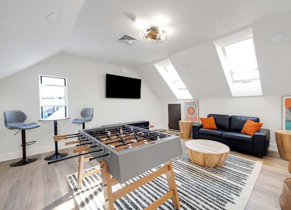 A foosball table is in the middle of a living room.