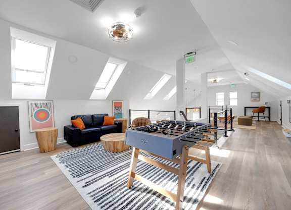A room with a long table and a couch.