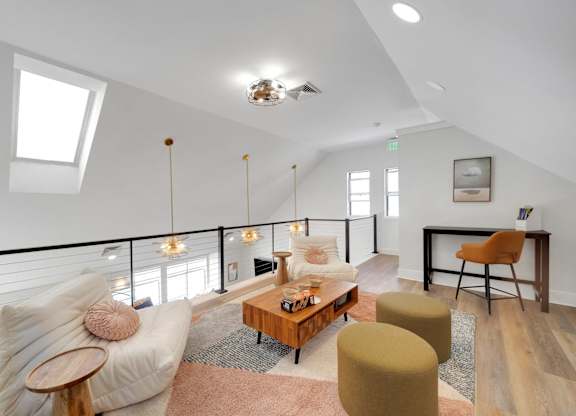 A living room with a white couch and a wooden coffee table.