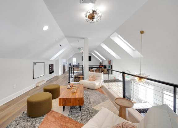 A living room with a white couch and a brown coffee table.