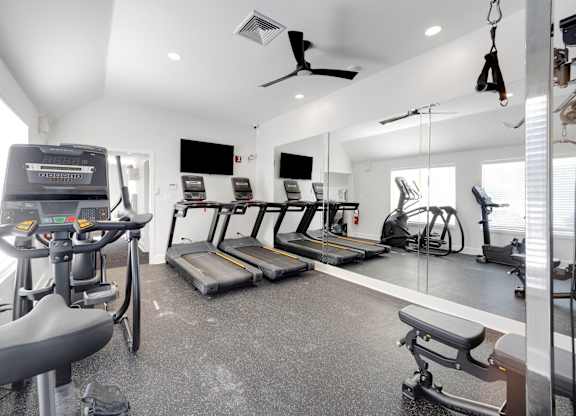 A spacious home gym with a variety of exercise equipment.